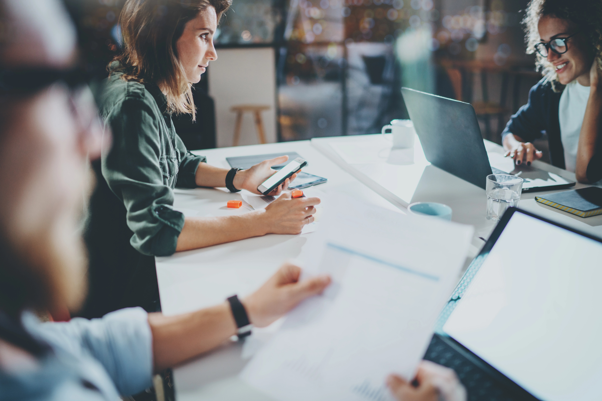 Group of young coworkers work together modern coworking studio at night.Horizontal.Blurred background.