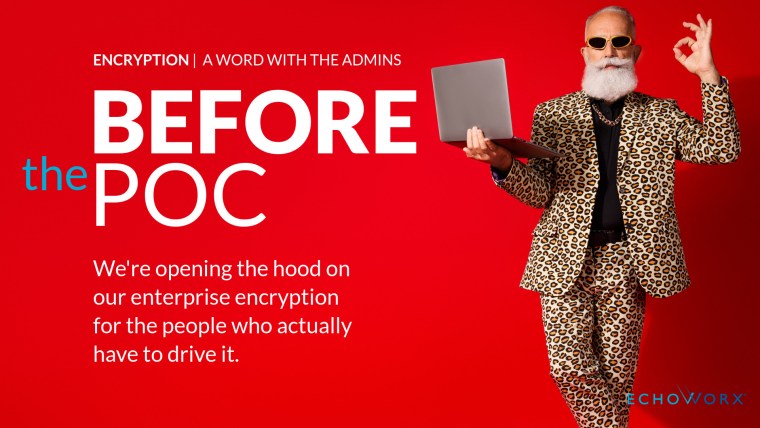 Man in a suit holding a laptop while giving the OK hand gesture