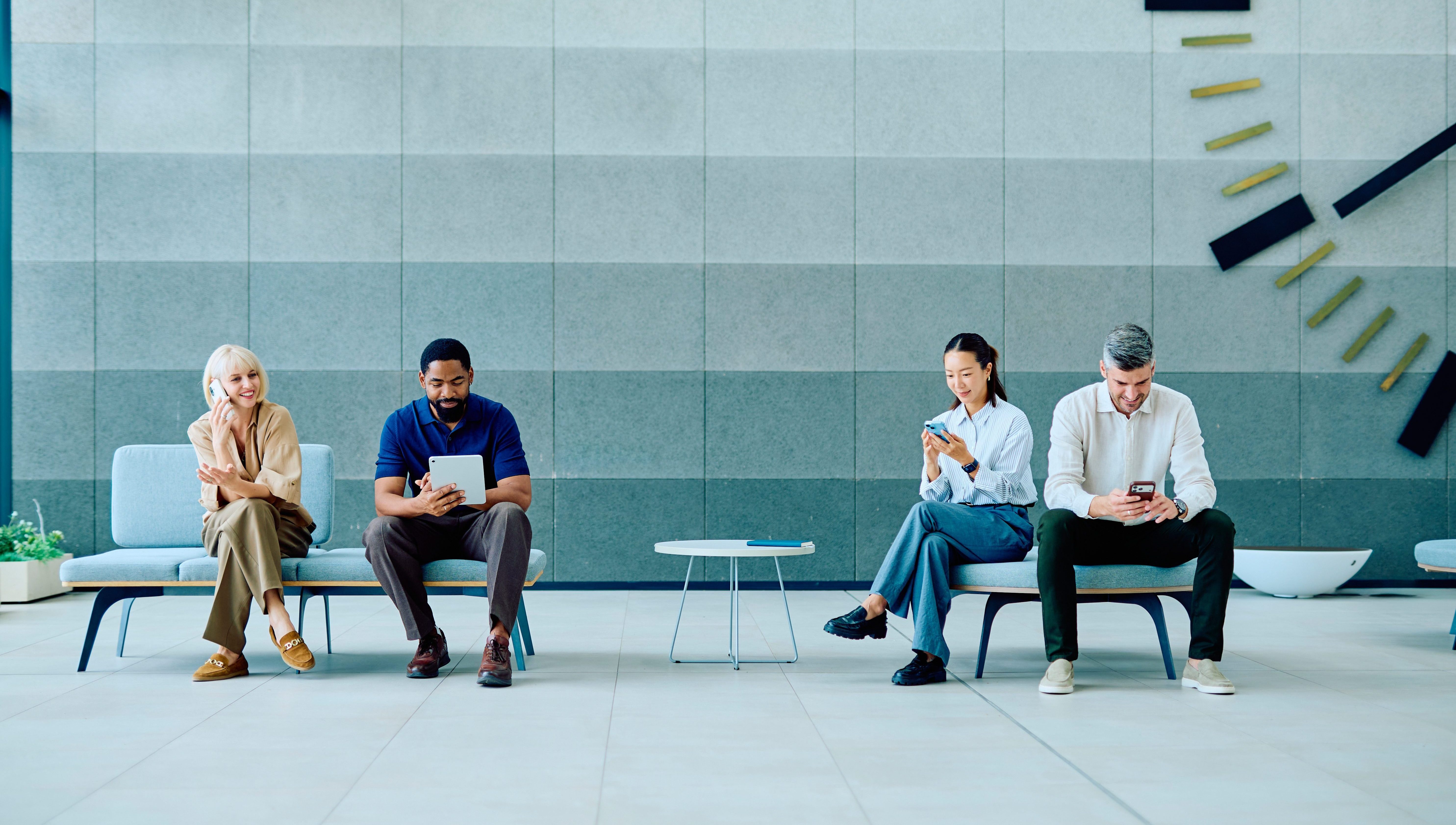 Diverse people waiting in modern office reception area